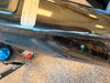 Close-up of a glossy black bicycle frame with a white inventory label reading '952241384 LEVO 4 PRO BLK S4 80%'.